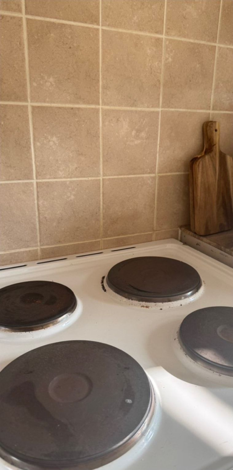Before cleaning: electric hob and tiled splashback